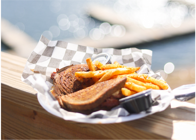 A basket of fresh food on the waterfront rail at The Grille
